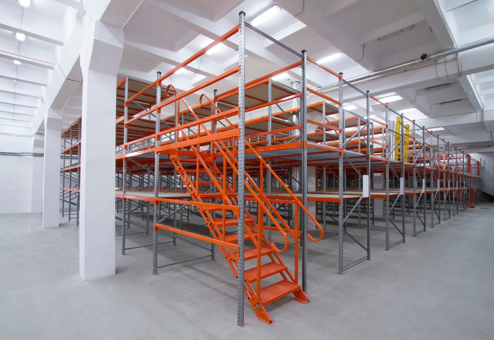Integrated safety guardrails and heavy-duty staircase for mezzanine access.