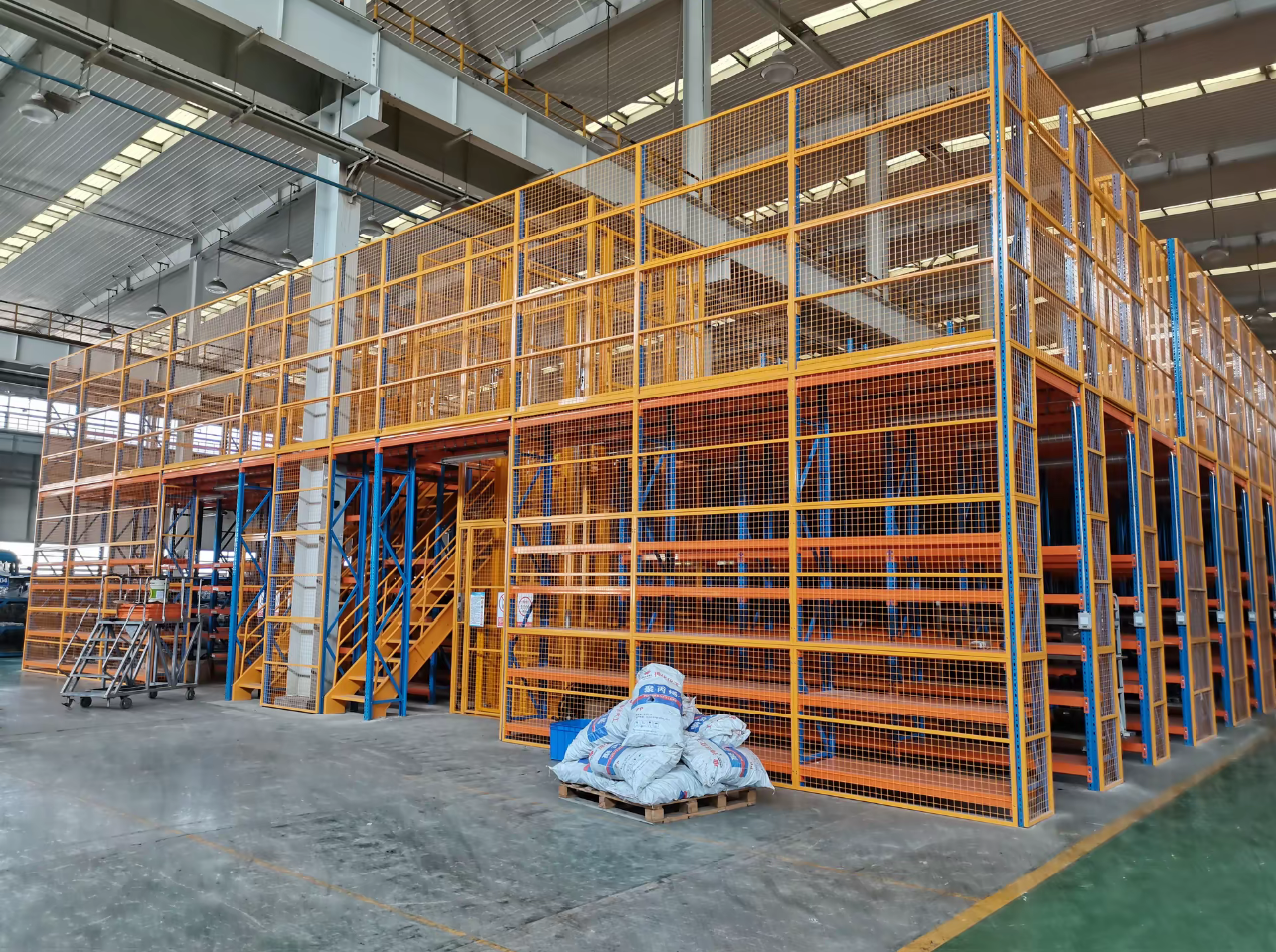 Multi-tier steel mezzanine floor platform system to maximize vertical warehouse space.